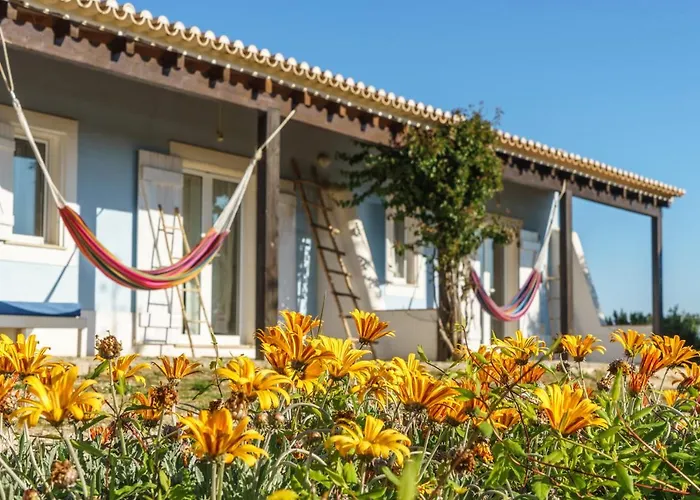 Guest rooms with hammocks and flowering garden at Monte Velho